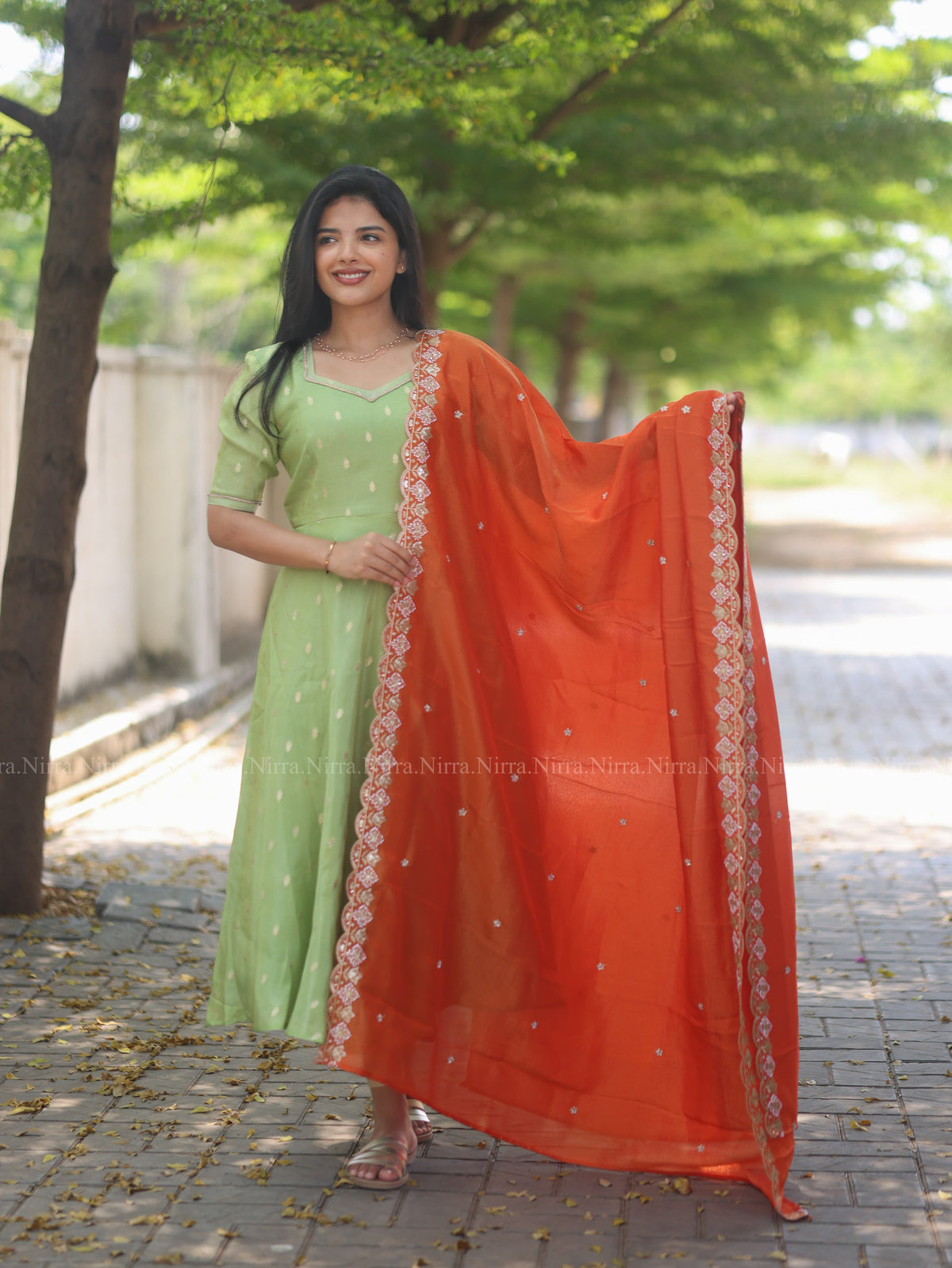 Green tissue umbrella cut Anarkali paired with orange tissue shawl