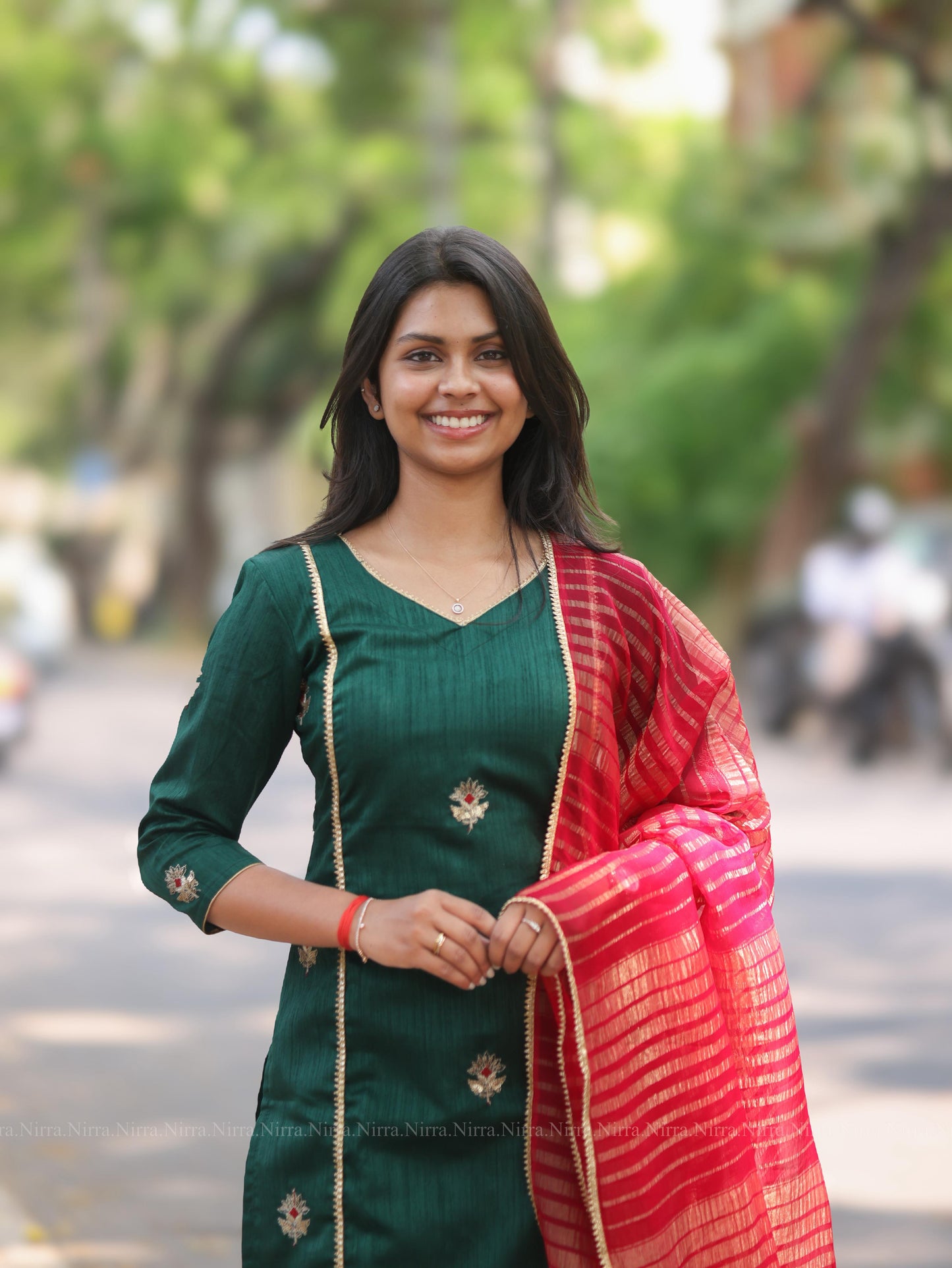 Bottle green embroidery kurti with red tissue shawl