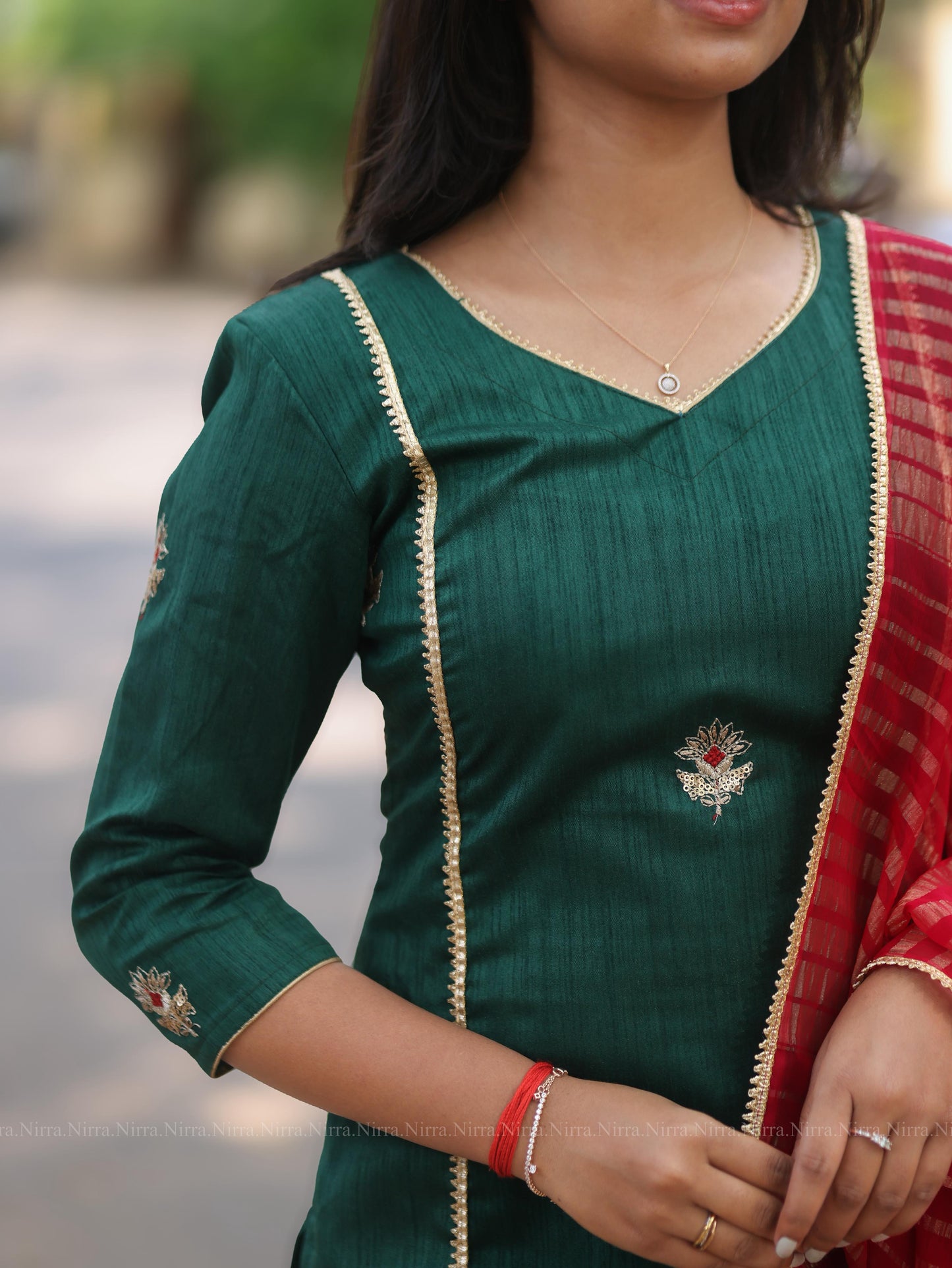 Bottle green embroidery kurti with red tissue shawl