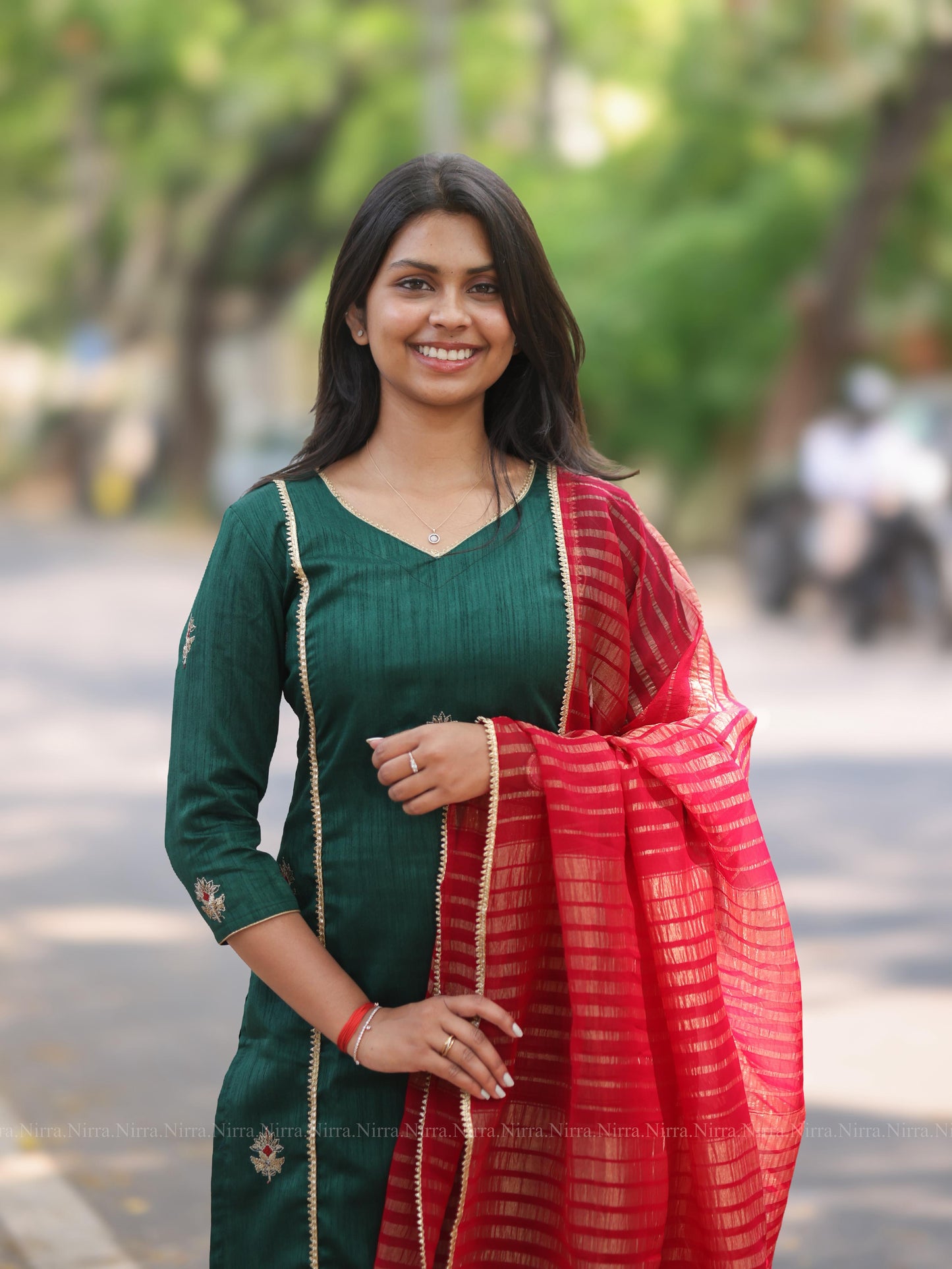 Bottle green embroidery kurti with red tissue shawl
