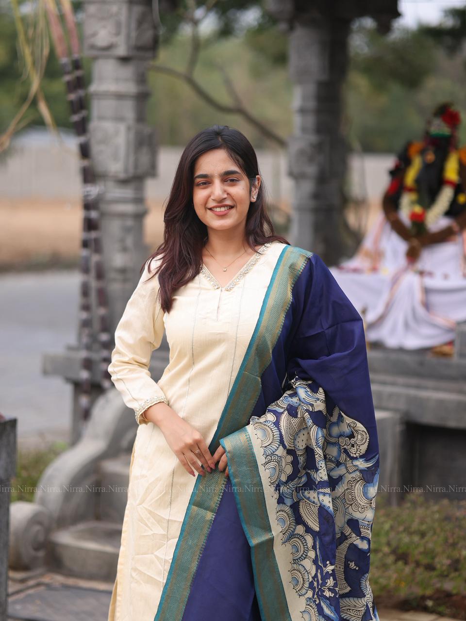 Cream raw silk kurti with crystal lace work paired with ink blue hand painted Kalamkari shawl