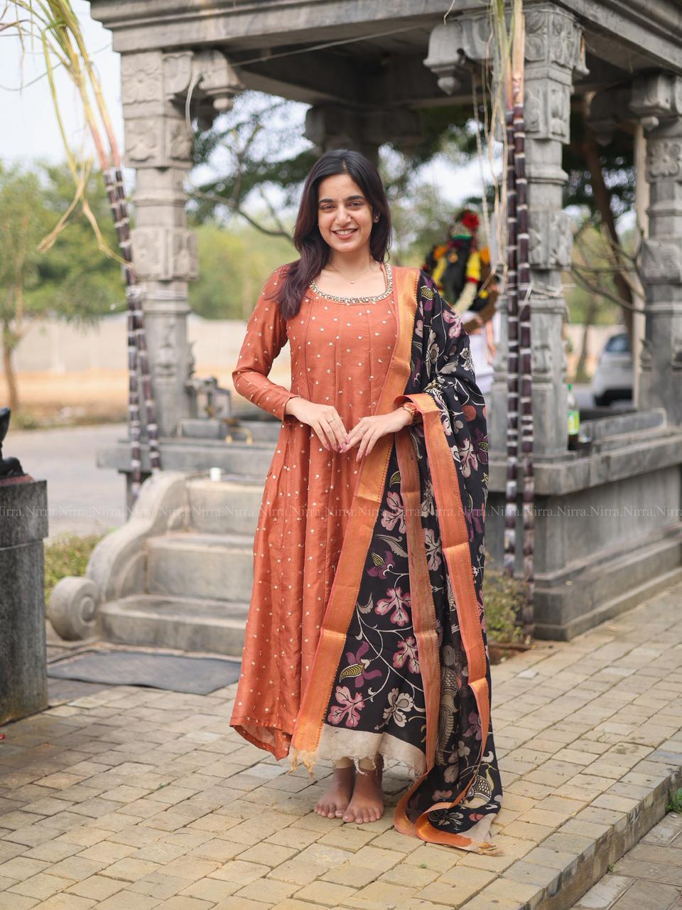 Rustic orange silk embroidery Anarkali with crystal lace work paired with black hand painted kalamkari shawl