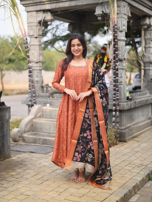 Rustic orange silk embroidery Anarkali with crystal lace work paired with black hand painted kalamkari shawl