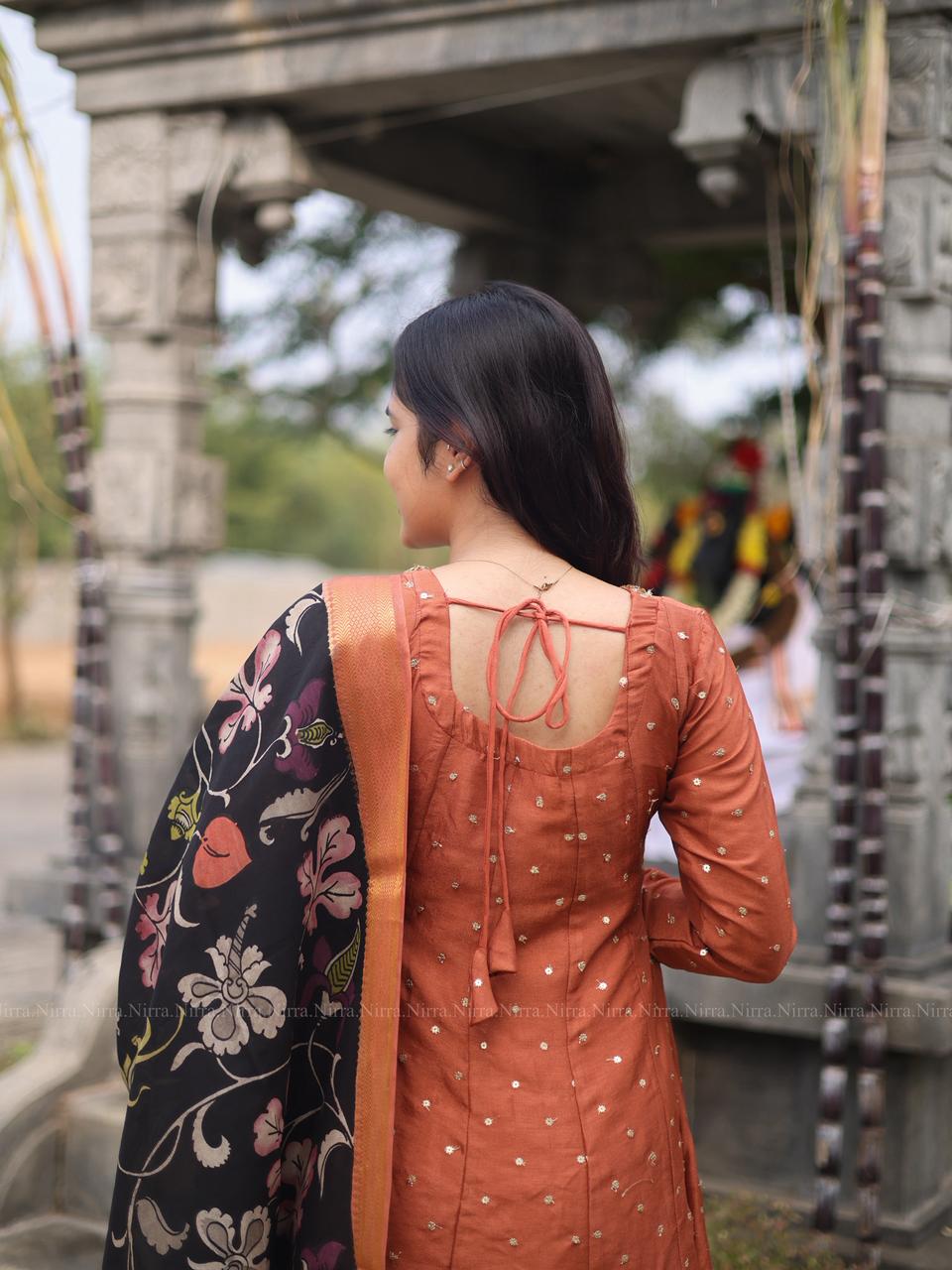 Rustic orange silk embroidery Anarkali with crystal lace work paired with black hand painted kalamkari shawl