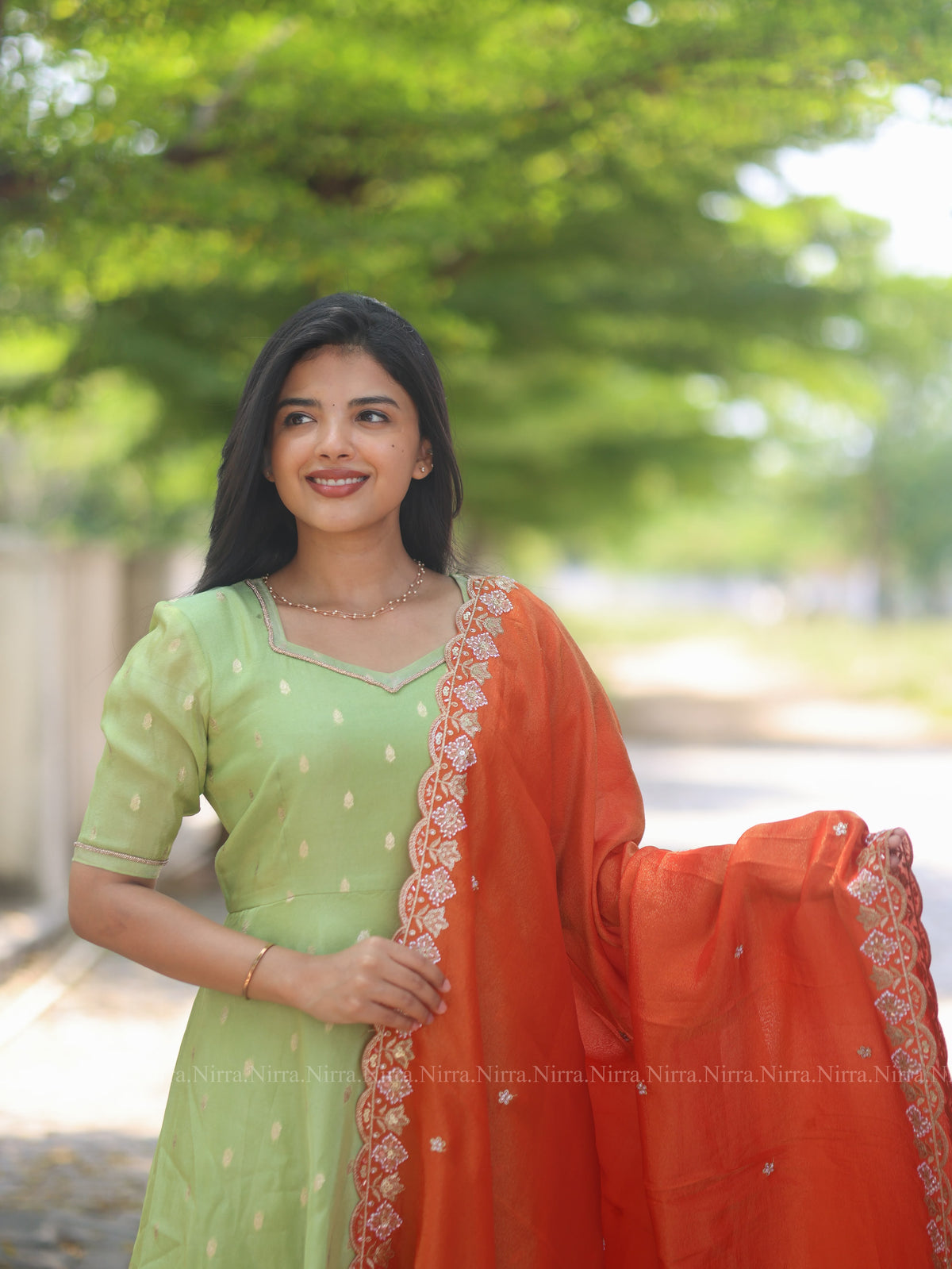 Green tissue umbrella cut Anarkali paired with orange tissue shawl