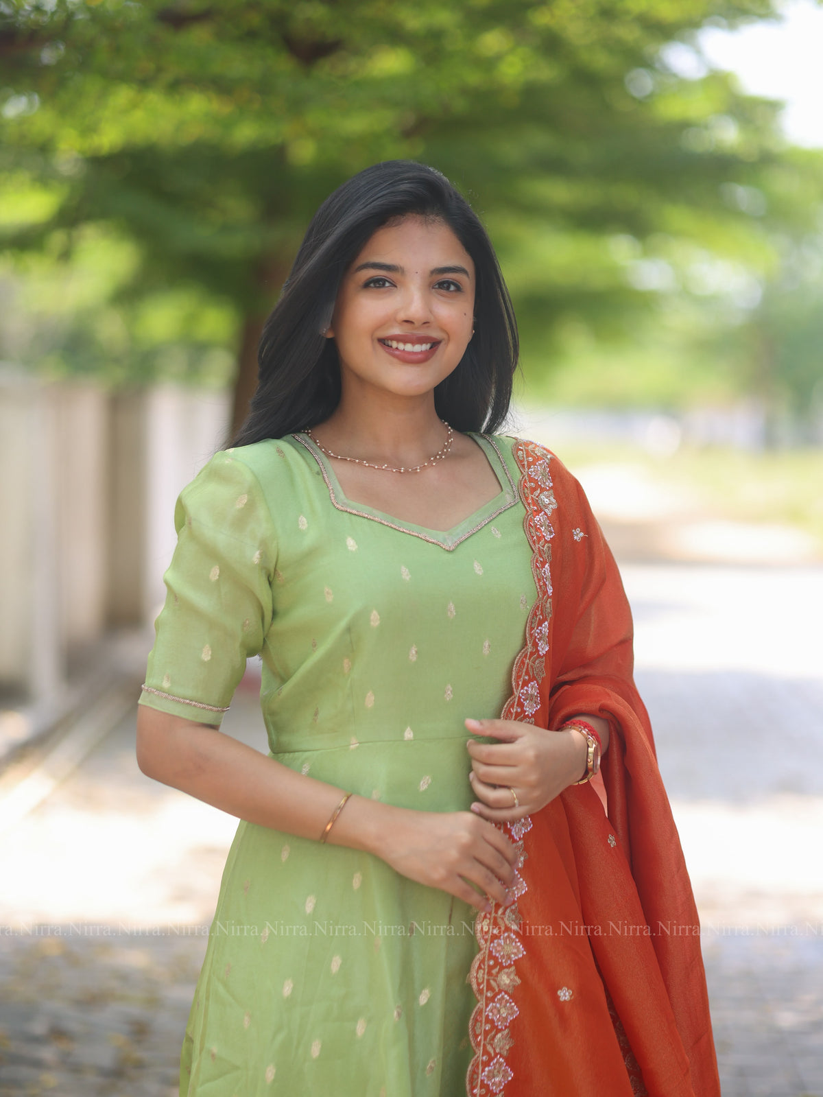 Green tissue umbrella cut Anarkali paired with orange tissue shawl