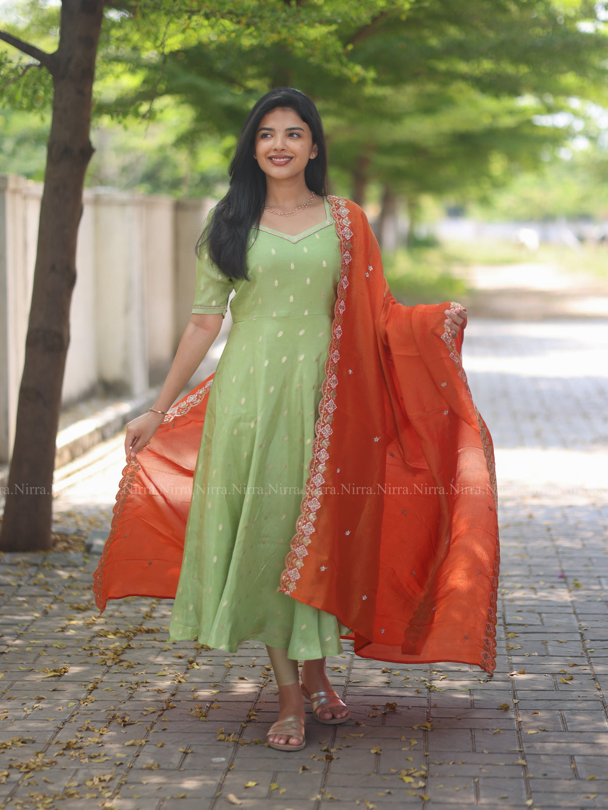 Green tissue umbrella cut Anarkali paired with orange tissue shawl