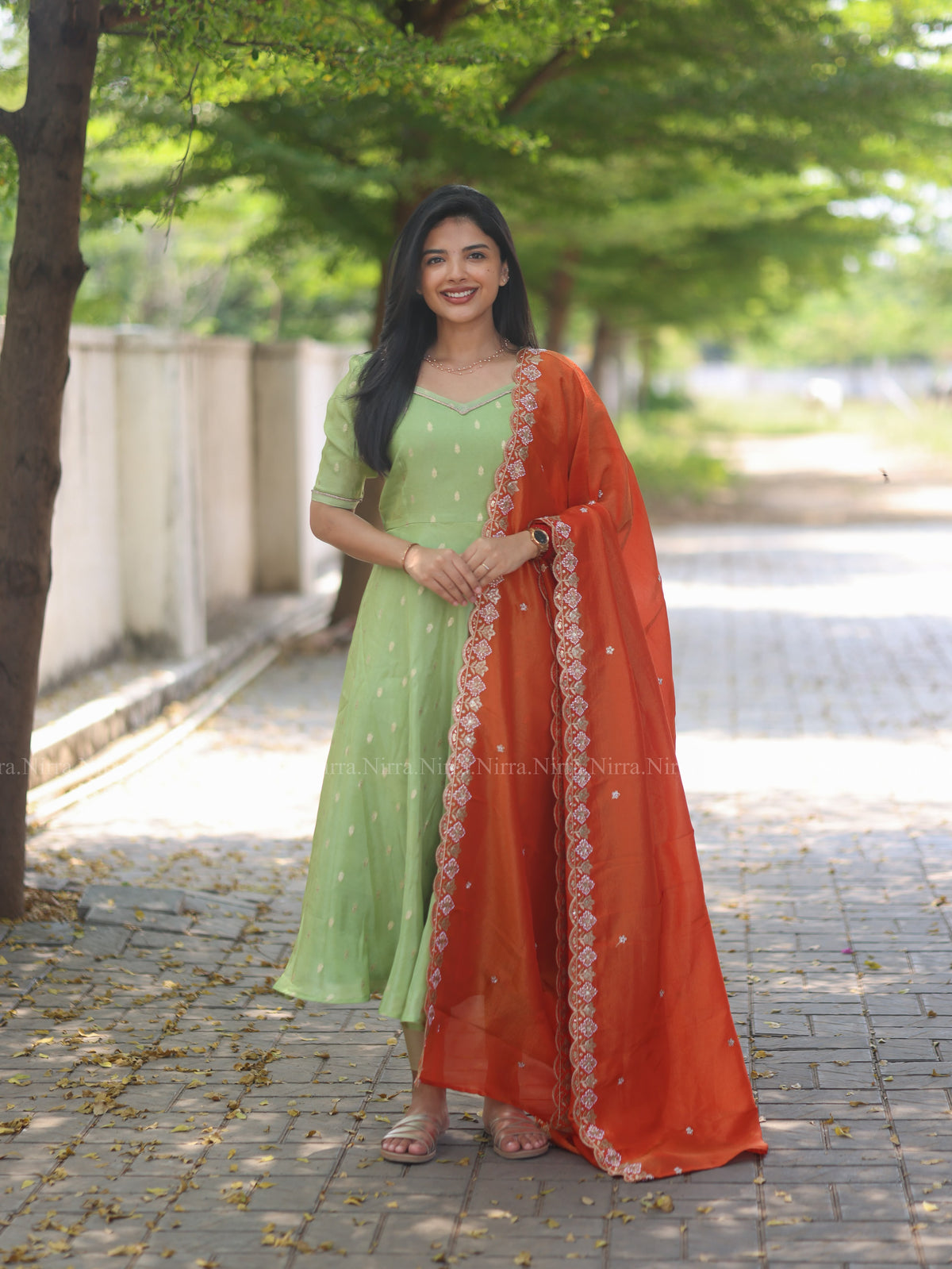 Green tissue umbrella cut Anarkali paired with orange tissue shawl